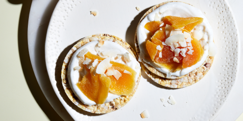 coconut yoghurt, dried mango & toasted coconut on Corn Thins slices